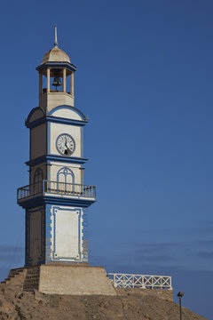 Historic wooden clock tower from the era of nitrate mining in the Atacama Desert, in the coastal town of Pisagua in the Tarapaca Region of northern Chile.