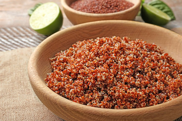 Bowl with boiled quinoa grains on kitchen table