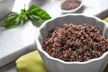 Bowl with boiled quinoa grains on kitchen table