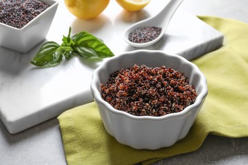 Bowl with boiled quinoa grains on kitchen table