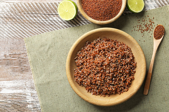 Bowl with boiled quinoa grains on kitchen table