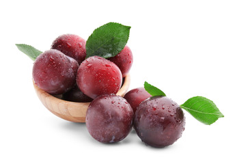 Bowl with fresh ripe plums on white background