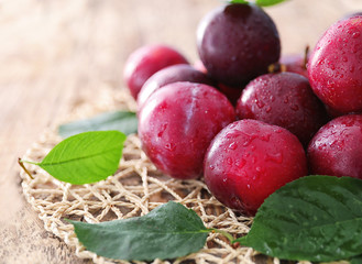 Fresh ripe plums on table, closeup