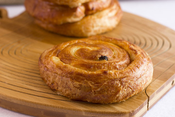 Twisted bun with raisins from puff pastry
