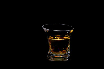glass beaker filled with a beautiful alcoholic drink, on a black background