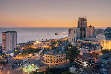 Fototapeta na wymiar Durres, Albania. View from above on the embankment of the seaside town of Durres located on the Adriatic coast. Sunset sunset overlooking the Venetian Tower with a cafe on the roof.