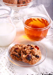 Oat cookies with cranberry, dried apricot and nuts on saucer