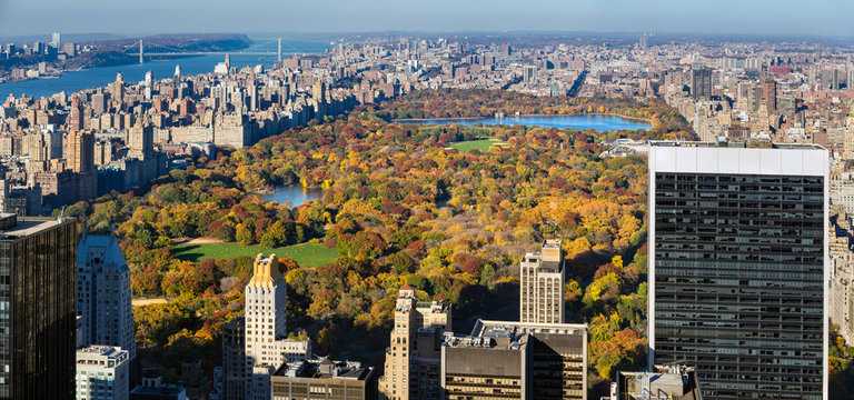 Elevated view of Central Park in autumn colors with skyscrapers and buildings of the Upper West Side, Upper East Side and the distant George Washington Bridge  Manhattan, New York City