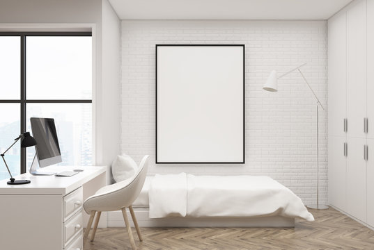 White brick bedroom, computer and poster
