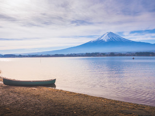 silhouette boat on ground at side of lake kawaguchi on morning time with fuji mountain background