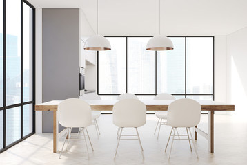 White kitchen with a long table