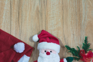 Obraz na płótnie Canvas Santa Claus doll with Santa Claus red hat in Christmas day on wooden background with copy space