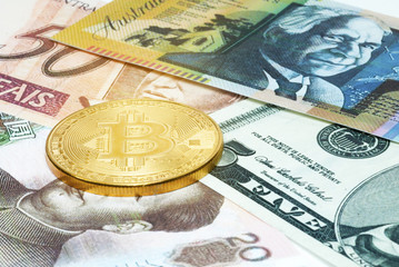 Golden Bitcoin coin on close up
