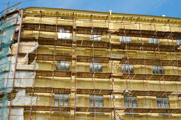 Construction scaffolding on the facade of the house.