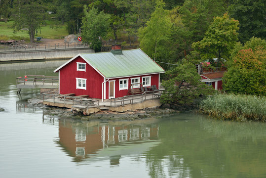  Traditional wooden red scandinavian house on shoreline of Turku archipelago island in Baltic Sea