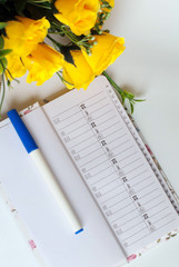 Blank  phonebook and Flowers on a white background
