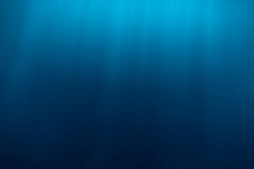 Water texture underwater and sun rays. Blue ocean in underwater