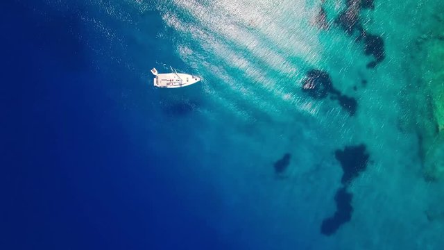 4K (UHD) Aerial view of boats mooring in  Agios Nikolaos blue caves  in Zakynthos (Zante) island, in Greece 