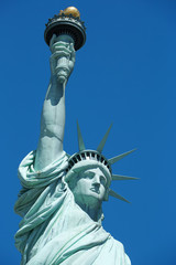 Fototapeta na wymiar Statue of Liberty with torch detail in a sunny day, blue sky in New York