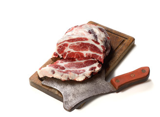 Raw pork on cutting board isolated on white background