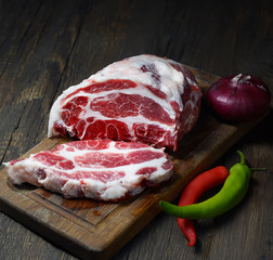 piece of raw pork on a wooden background