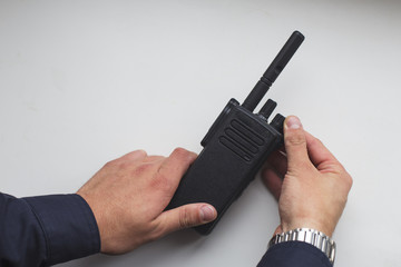 Hands holding a portable walkie-talkie © lexashka
