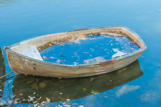 Old , abandoned boat at lakeside.