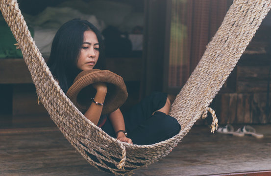 Asian woman is sitting on cradle., relaxing concept. image vintage style.