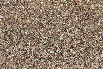 Background pattern of small pebbles, sand on the seashore
