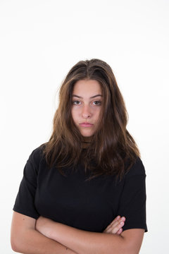 Image of sad young woman standing isolated over white background. Looking at camera.