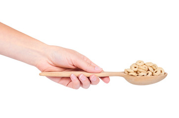 beige rings corn flakes in hand isolated on white background