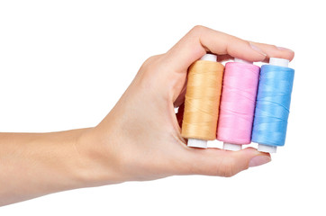 spool of thread in hand isolated on white background