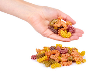 Pasta spiral in hand isolated on white background