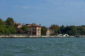 Fototapeta na wymiar View from the sea at the residential district of waterside with bridge in Venezia, Venice, Italy, Europe 