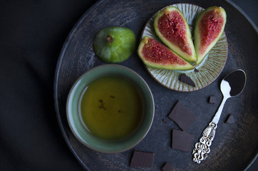 Cup of tea, chokolate, spoon and fig