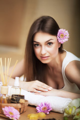Obraz na płótnie Canvas Portrait of a beautiful woman. Skin Care. Spa treatments. Flower in hair. The concept of beauty and health. In the massage salon.
