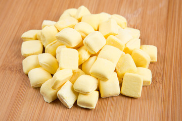 Pile of yellow mints on a wood background