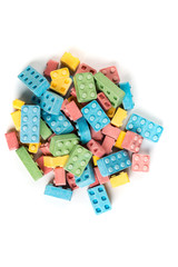 Fototapeta na wymiar Pile of multicolored candy building blocks isolated on a white background