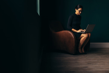 Asian businesswoman working on laptop in office