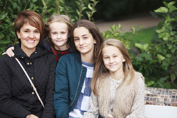 Happy mother and three sisters girls