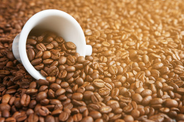 Coffee cup on the background of coffee beans on a sunny afternoon