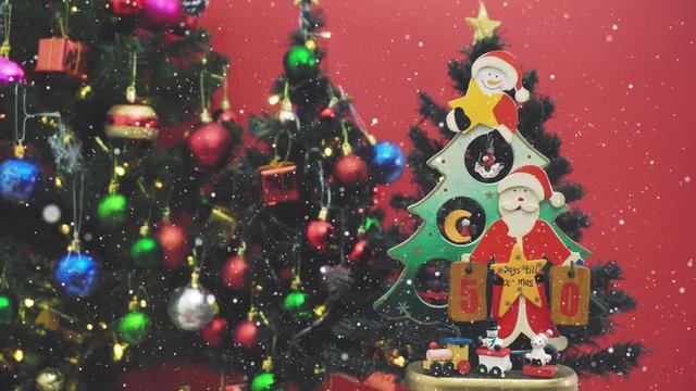Greeting Season concept.Dolly of Santa Claus show 50 days till Xmas with ornaments on a Christmas tree with decorative light in 4k (UHD)