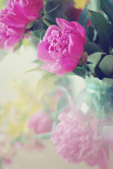 bouquet of peonies in a glass vase, a soft focus, background