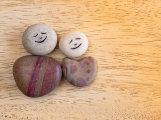 Applique from sea stones on a wooden table.
