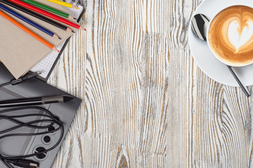 notebook with pencils and graphic tablet with coffee