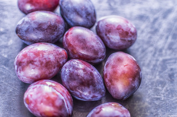 plums close up on a blue background