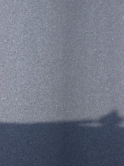 Texture of dry asphalt with shadow