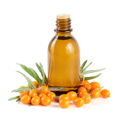 Sea-buckthorn oil with berries and leaves isolated on white background