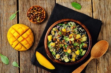 Mango black bean arugula pumpkin seed quinoa salad