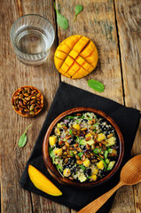 Mango black bean arugula pumpkin seed quinoa salad
